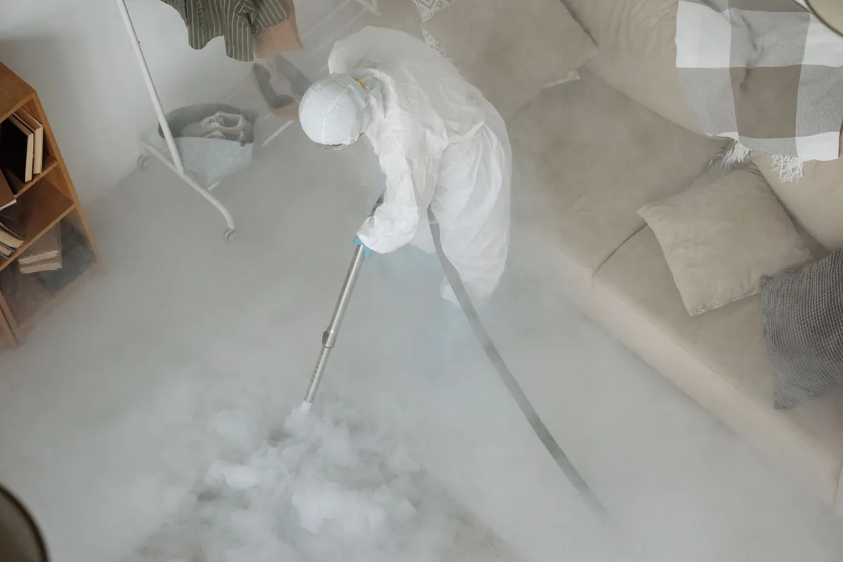 Biohazard cleanup technician in protective equipment, Bernie, MO